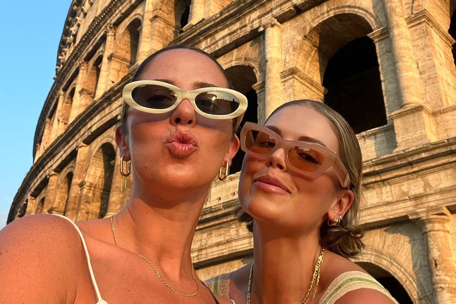 Two friends taking a selfie in front of the Colosseum